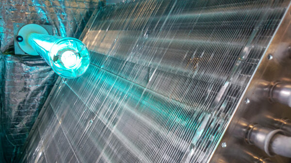 A large metal object featuring a blue light, identified as a blue tube UV coil.